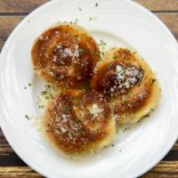 Garlic Rolls · Fresh homemade bread with parmesan cheese on top.