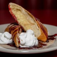 Deep-Fried Cheesecake · Creamy cheesecake, rolled up in a pastry shell and deep-fried, served with raspberry jam, su...