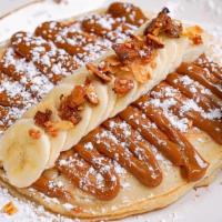 Dulce De Leche Pancake · 2 large pancakes, dulce de leche, fresh banana, candied almonds, maple syrup on the side.