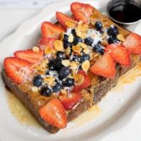 Almond Butter French Toast · almond butter, strawberries, blueberries, candied almonds, coconut flakes, honey.