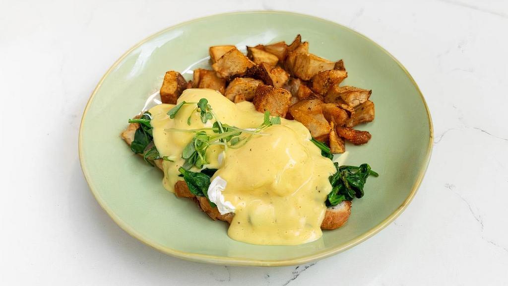 Florentine Benedict · open faced croissant topped with sautéed spinach, 2 poached eggs and hollandaise sauce on side, served with breakfast potatoes.