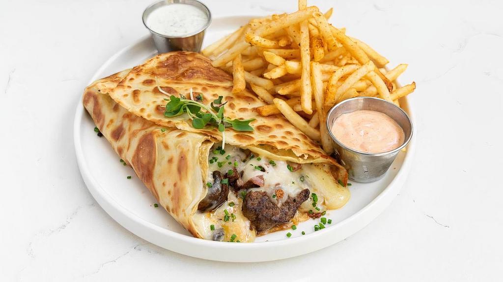 French Cowboy Crepe · stuffed with diced beef filet, sautéed onions and peppers, Monterey Jack, served with French fries.