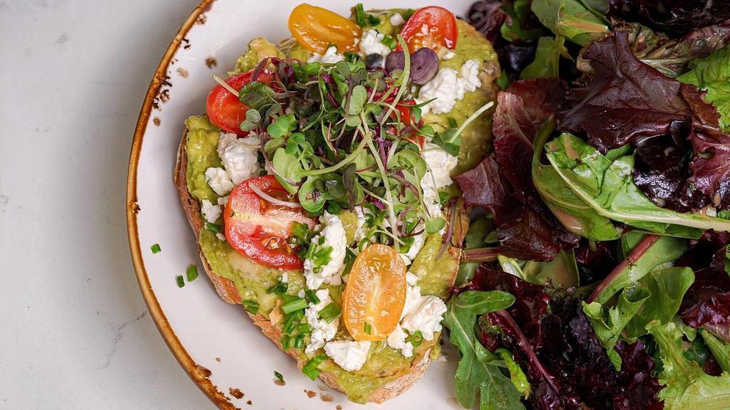Avocado Toast · on toasted multigrain bread, avocado spread, feta cheese, cherry tomato. Served with salad on the side.