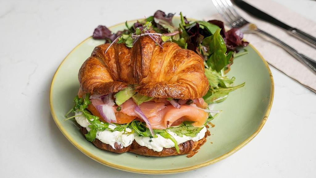 Smoked Salmon Croissant Sandwich · toasted large French croissant, smoked salmon, chives cream cheese, arugula, tomato, avocado, served with field green salad