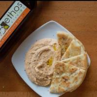 Hummus Served With Warm Pita · Ground Garbanzo Beans with Roasted Garlic & Olive Oil; Served with Warm Pita.