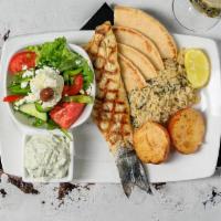 Bronzini Platter · Mediterranean grilled bronzini, imported fresh from Greece, served with a side of Greek sala...