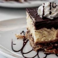 Triple Layer Cheesecake · layers of cheese cake, walnuts, & shredded phyllo topped with Belgian chocolate ganache. Top...