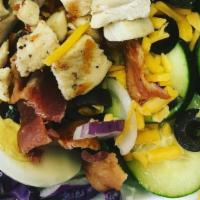 Cobb Salad · Garden salad topped with fried or grilled chicken, crispy bacon, egg and shredded cheeses. T...