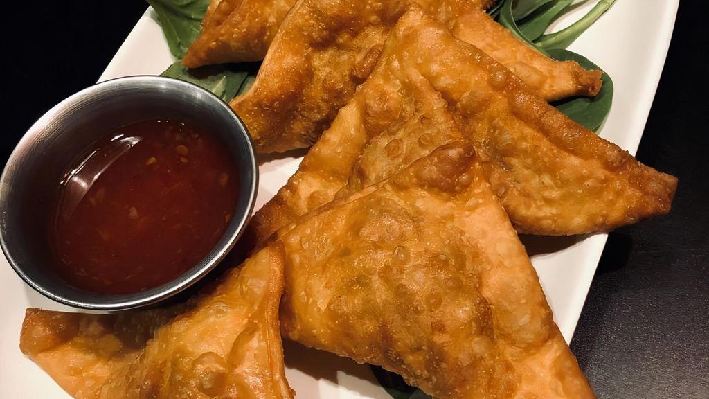Crispy Pork Wonton · Six pieces. Wontons stuffed with pork, egg, and scallions. Flavors of sesame and soy. Served with sweet chili.