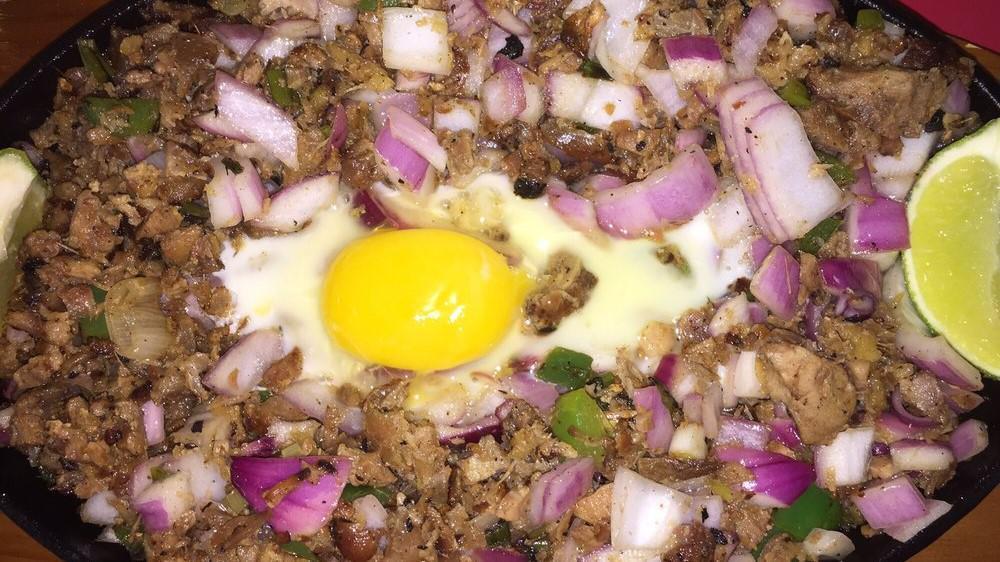 Pork Sisig · Pork chopped then pan fry with soy, onions, and other seasonings topped with egg.