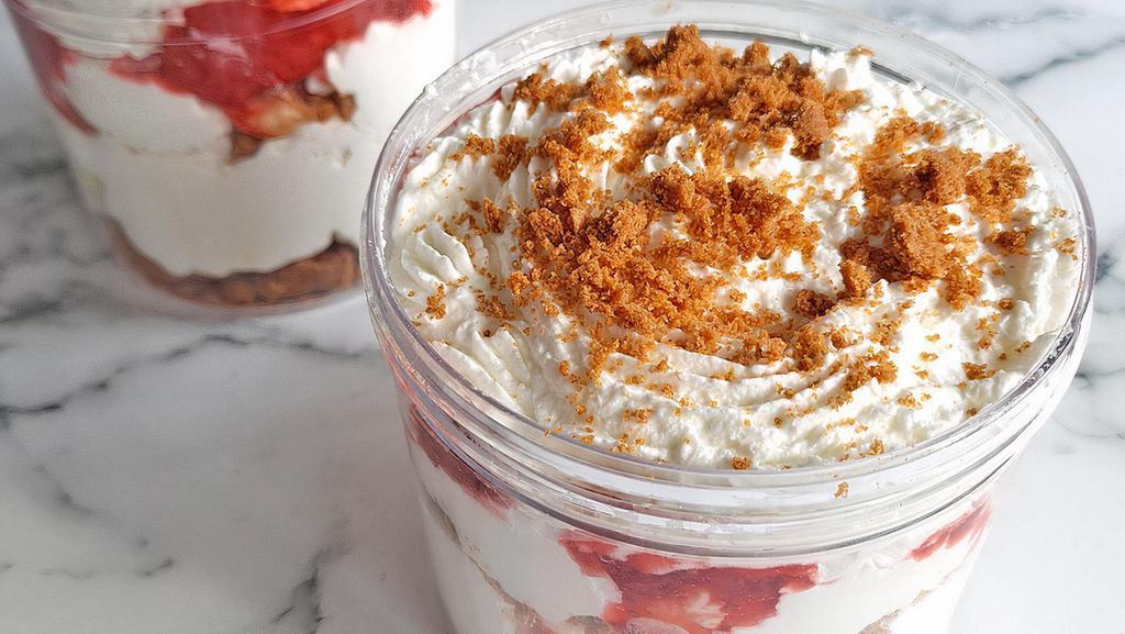 Strawberries & Cream · A favorite. Creamy, delicious cheesecake layered with graham cracker crust, whipped cream, strawberries, and cookie crumbs.