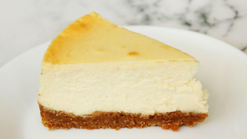 Ny Cheesecake Slice (Plain) · Large slice with whipped cream and thick graham cracker crust.