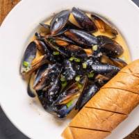 Mussels · Served in garlic cream sauce with a baguette.