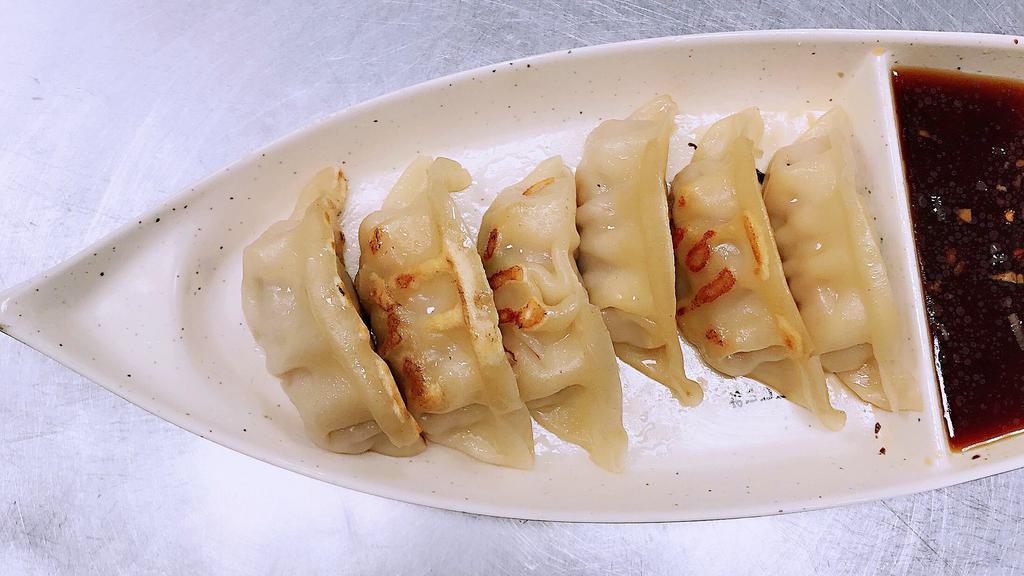Gyoza · Six pieces of pan fried pork dumplings.