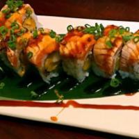 * Ichiban Roll · Shrimp tempura, mango topped with seared salmon, chef's special sauce.