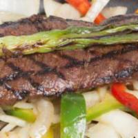 Carne Asada · Grilled skirt steak presented on a bed of sizzling onions and bell peppers. Served with Mexi...