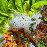 Pork Belly Bo Ssam (Lettuce Wraps) · tender slices of pork belly, bibb lettuce, kimchi radishes, scallions, ssamjang sauce on side