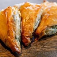 Spanakopitas · petite Greek pies of spinach, feta and herbs baked between layers of filo (V)