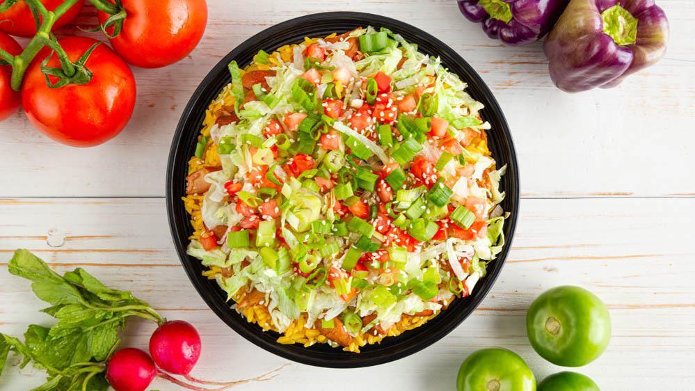 Asian Chop-Chop® (Large) · Our tangy teriyaki chicken thighs, lettuce, tomatoes, scallions, and sesame seeds over yellow rice (or your choice of base). Served with 2 Signature Sauces & pita bread.