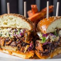 Carnitas Sandwich · slow roasted pork, coleslaw, pickle & a thick onion ring with bbq