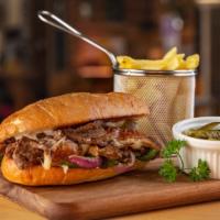 Lechon Asu Que Tal Lechon Sandwich · Peruvian style sandwich made on french bread with seasoned pulled pork, pepper and a lime sa...