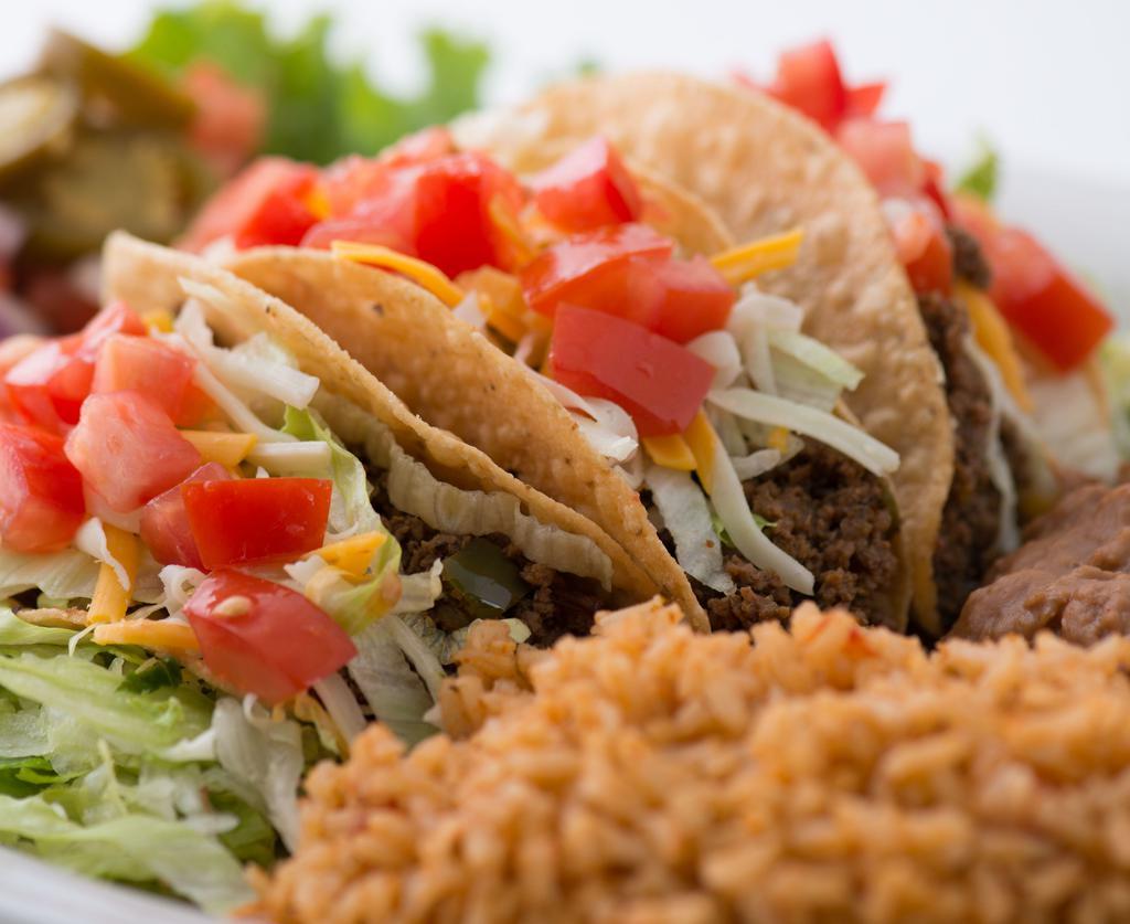 Crispy Tacos · You know what we mean.  Seasoned ground beef, lettuce, cheese and tomatoes. Served with Mexican rice and refried beans.