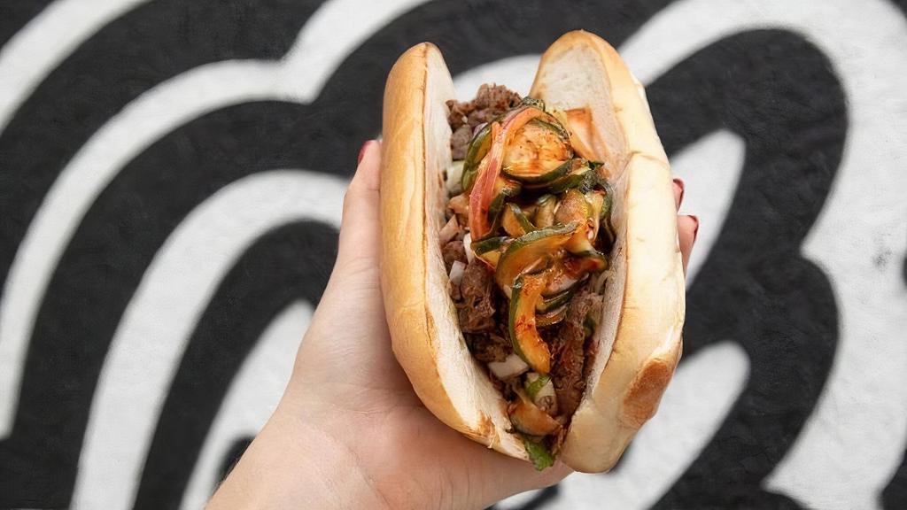 Yumbii Philly · Protein Of Your Choice Topped With Sriracha Queso + Red Onion + Green Onion + Homemade Cucumber Kimchi.