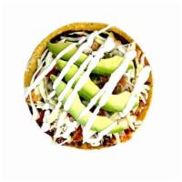Tostada · Crunchy Tortilla, Sour Cream, Refried Beans, Cabbage, Tomato, Avocado and your choice of Tac...