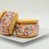 Happy Face Sandwich (2-Pack) · Sugar cookies, vanilla ice cream, rolled in rainbow sprinkles. Brings two sandwiches.