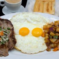 Bistec A Caballo · Grilled steak with two fried eggs on top.