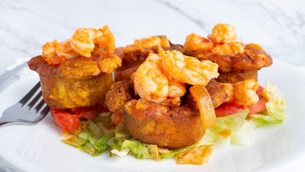 Tostones Con Camaron · Green plantains filled with shrimps.