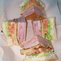 Club Sandwich · American bread, bolo ham, turkey, Swiss cheese, bacon, lettuce and tomato.