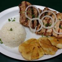 1/2 Pollo A La Brasa · 1/2 Grilled chicken with onions on top.
