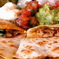 Quesadilla · Flour tortillas filled with cheddar cheese, onions, peppers and your choice of beef or chick...