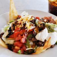 Taco Salad · Fresh mixed greens, diced tomatoes, diced onions, black olives, jalapeños, and shredded ched...