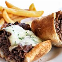 French Dip · Thin sliced roast beef and provolone in a hoagie bread. Served with au jus and fries. Served...