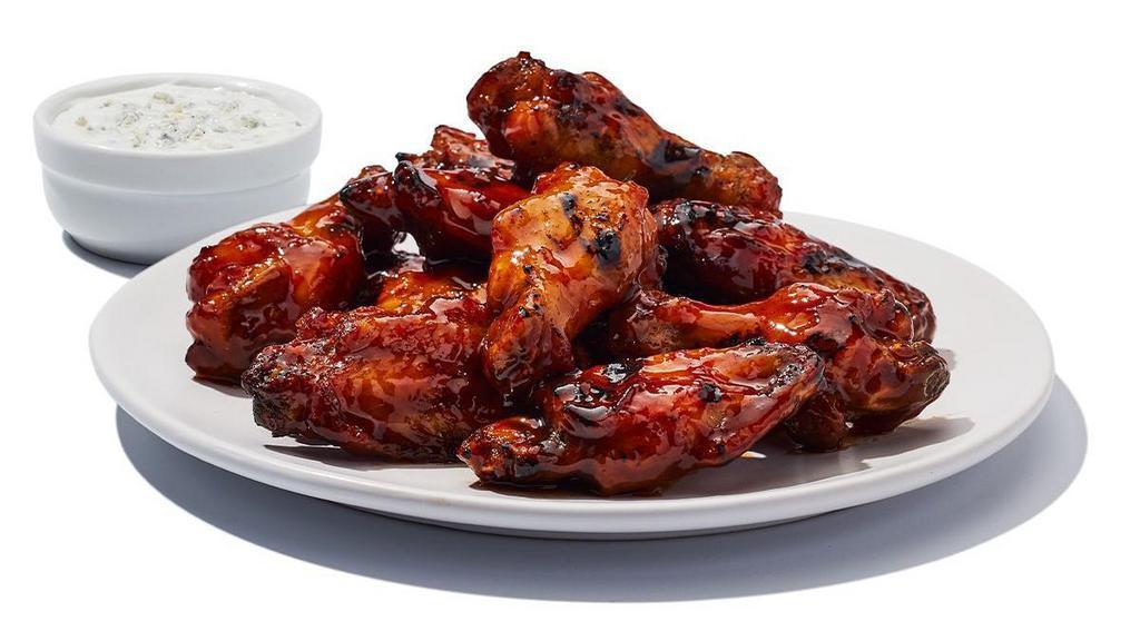 Daytona Wings · Naked wings tossed in Daytona sauce and grilled until caramelized. 820 cal | ranch or bleu cheese add 200 cal (Calories listed are for a 10 pc)