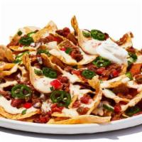 Tex-Mex Nachos Chili · Fresh-made corn chips loaded with cheese and chili, piled high with diced tomatoes, jalapeno...