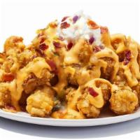Lots A Tots · Tater tots covered in bacon, cheese sauce, and sour cream.