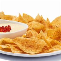 Chips & Queso · A creamy blend of melted cheeses mixed with roasted red and green peppers, topped with diced...