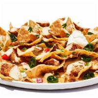 Tex-Mex Nachos Chicken · Fresh-made corn chips loaded with cheese and chili, piled high with diced tomatoes, jalapeno...