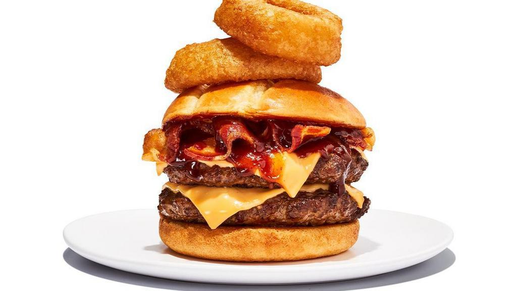 Western Bbq Burger · Two 1/4lb beef patties with BBQ sauce, cheddar cheese, bacon and onion rings on a toasted brioche bun. 940 cal