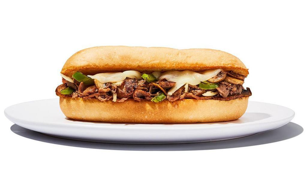 Philly Cheesesteak Sandwich · Shaved steak sauteed with onions, peppers and mushrooms topped with provolone cheese served on a toasted hoagie bun. Beef 920 cal | Chicken 1000 cal