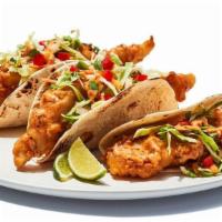 Fish Tacos Fried · Tempura battered cod served on soft tortillas with diced tomatoes, cabbage and house spicy s...