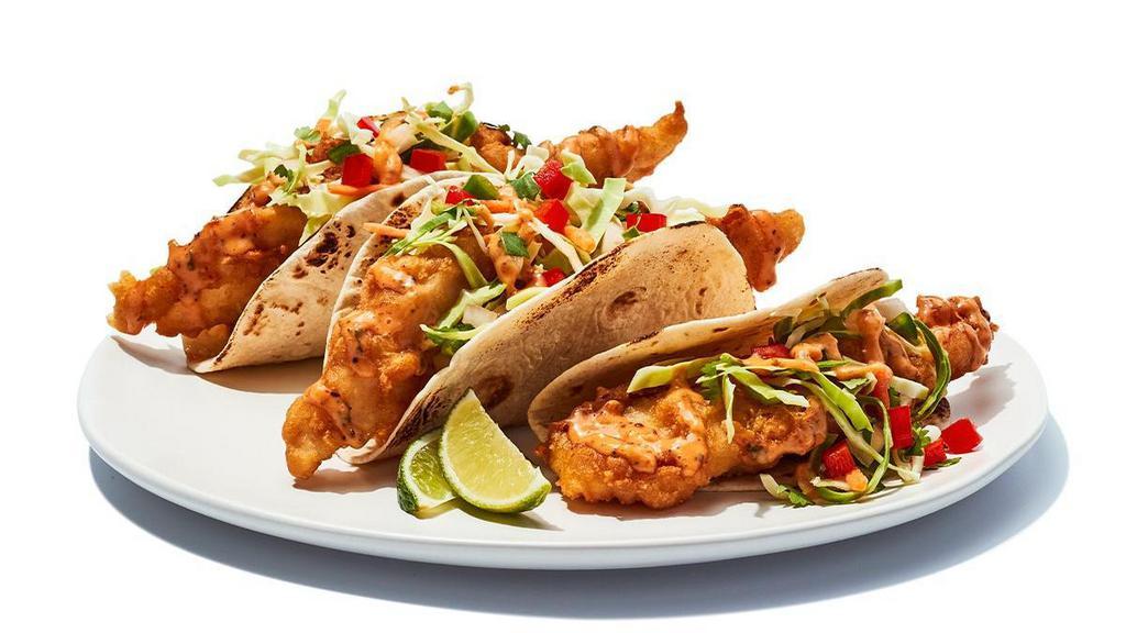 Fish Tacos Fried · Tempura battered cod served on soft tortillas with diced tomatoes, cabbage and house spicy sauce.   850 cal