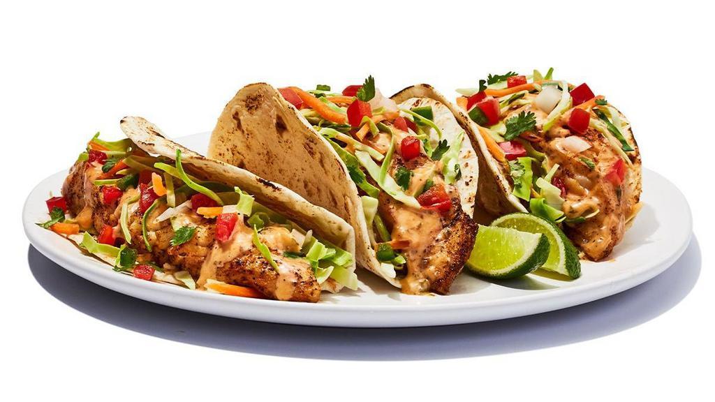 Fish Tacos Grilled · Grilled cod served on soft tortillas with diced tomato, cabbage and house spicy sauce. . 700 cal
