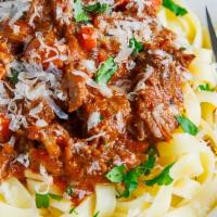 Fettuccine Bolognese · Green peas in a light chunky meat sauce with a touch of cream.