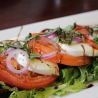 La Caprese Salad · Fresh mozzarella, sliced tomatoes, fresh basil, red onions, balsamic glaze, extra virgin oli...