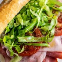Italian Classico Sub · Genoa salami, capicola ham, provolone cheese, lettuce, tomatoes, onions, drizzled with balsa...