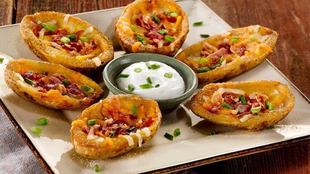 Loaded Potato Skins · Cheddar cheese, hickory-smoked bacon and green onions. Served with sour cream.